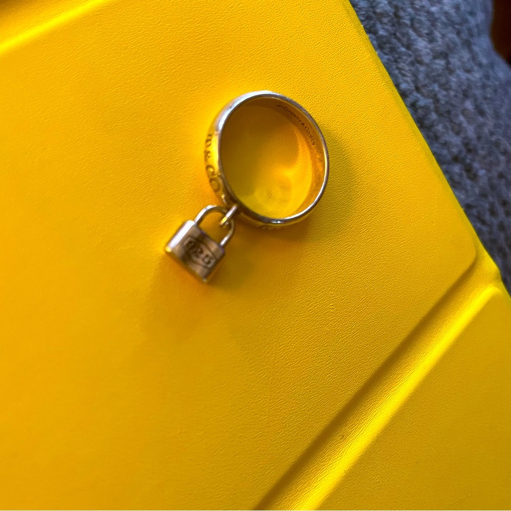TIFFANYS STERLING SILVER PINKY RING WITH LOCK.